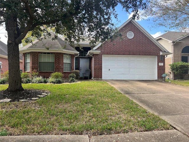 view of front of property featuring a front yard and a garage