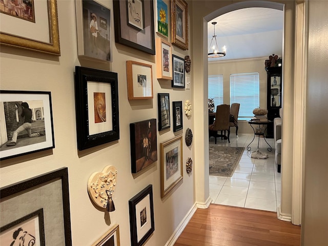 corridor featuring a notable chandelier and light hardwood / wood-style floors