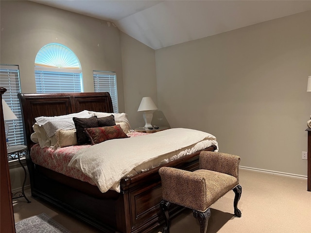 bedroom with carpet floors and vaulted ceiling