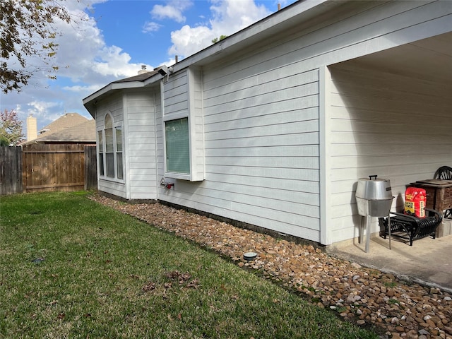 view of property exterior with a yard