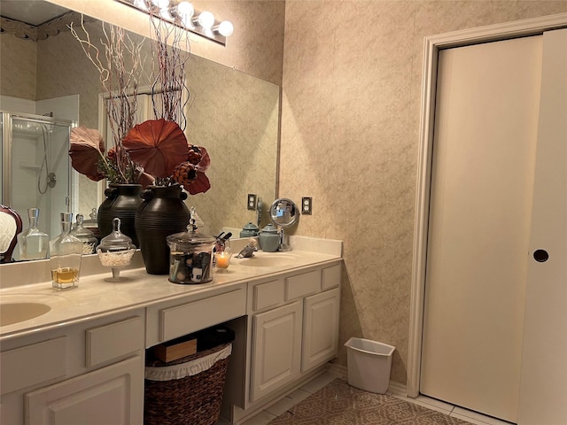 bathroom featuring tile patterned floors, a shower with door, and vanity