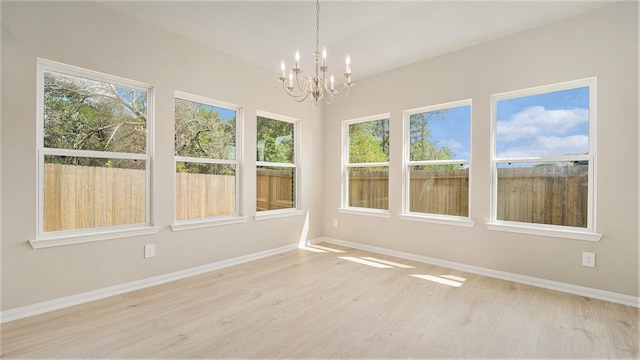 unfurnished sunroom featuring a notable chandelier