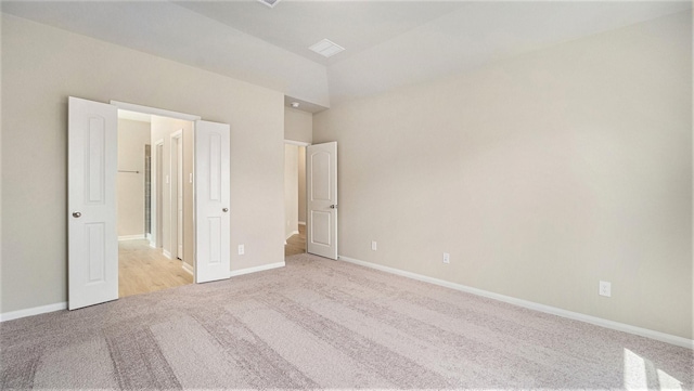 unfurnished bedroom featuring light carpet