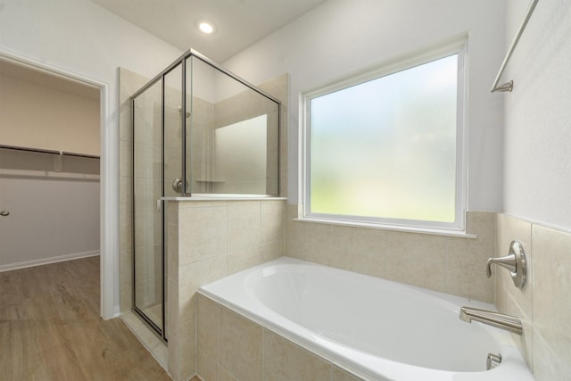 bathroom featuring separate shower and tub and wood-type flooring