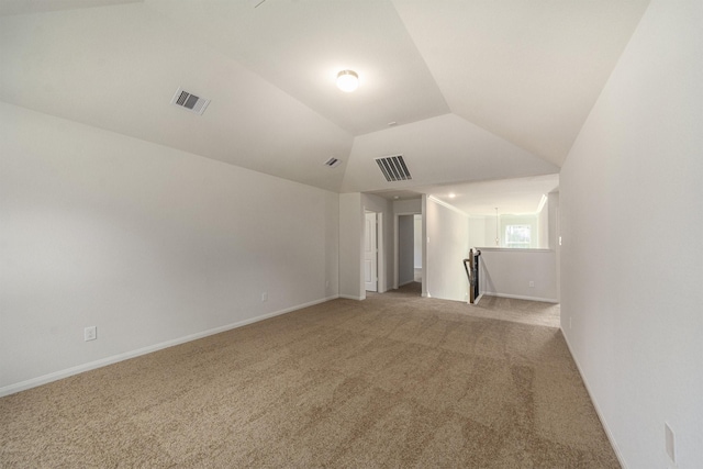 empty room featuring carpet flooring and lofted ceiling