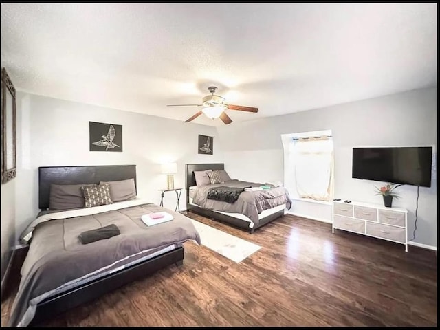 bedroom with ceiling fan and dark wood-type flooring