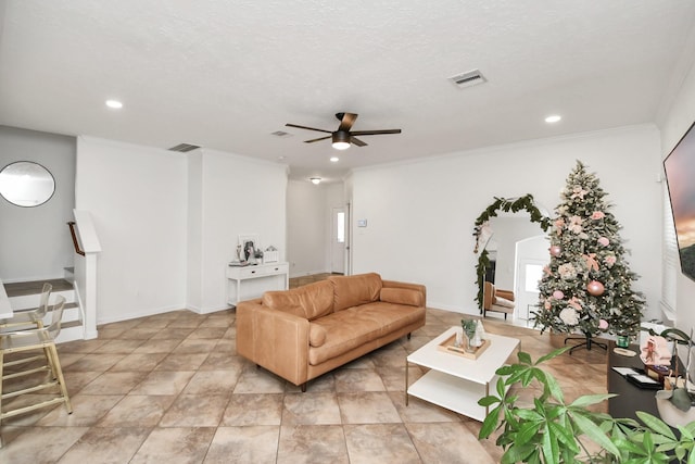 living room featuring plenty of natural light, ceiling fan, crown molding, and a textured ceiling