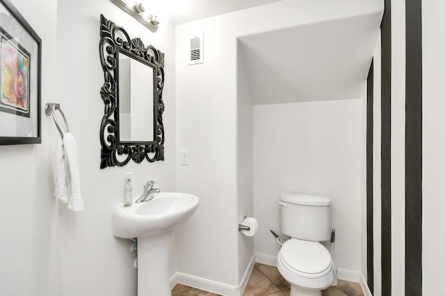 bathroom featuring tile patterned floors, toilet, and sink