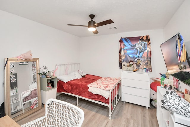 bedroom with ceiling fan and hardwood / wood-style floors