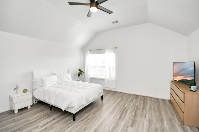 bedroom featuring ceiling fan, vaulted ceiling, and light wood-type flooring