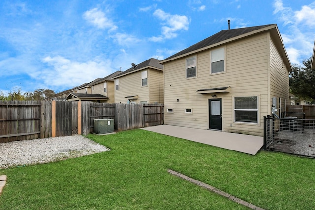 rear view of house with a yard and a patio area