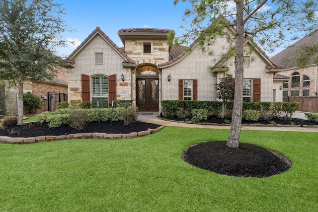 mediterranean / spanish-style house featuring a front lawn