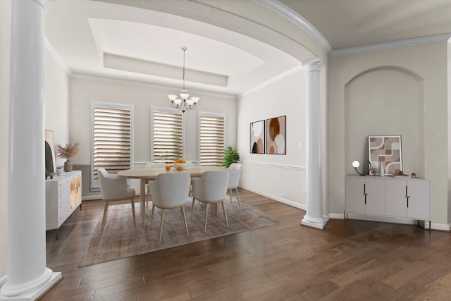 dining space featuring dark hardwood / wood-style floors, a raised ceiling, and a wealth of natural light