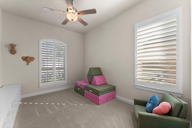 playroom featuring light carpet and ceiling fan