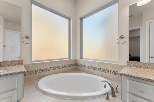 bathroom featuring vanity and a relaxing tiled tub