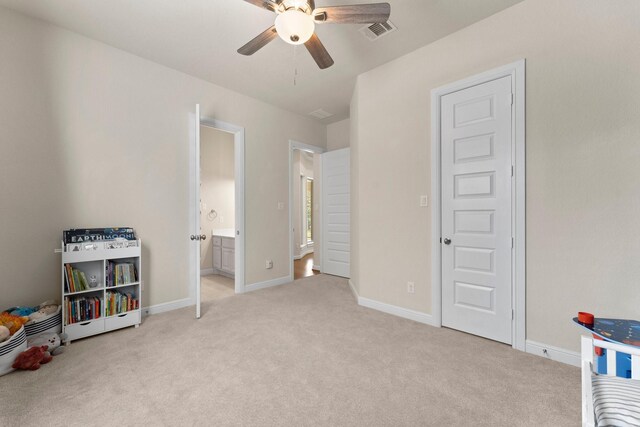 recreation room with ceiling fan and light colored carpet