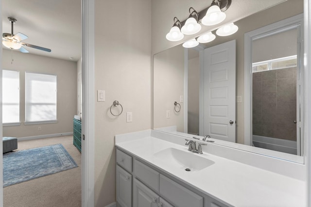 bathroom with vanity and ceiling fan with notable chandelier