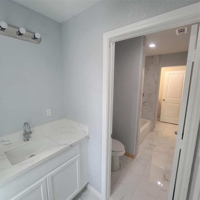 bathroom featuring vanity, toilet, and walk in shower