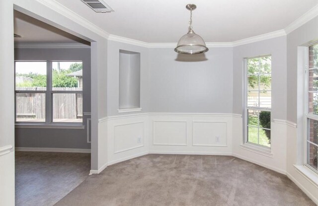 empty room featuring light carpet and crown molding