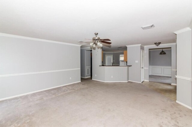 unfurnished living room featuring ceiling fan, crown molding, and light carpet