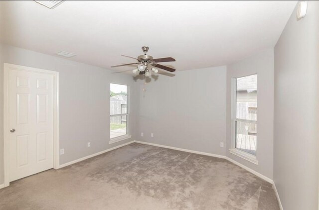 carpeted empty room featuring ceiling fan