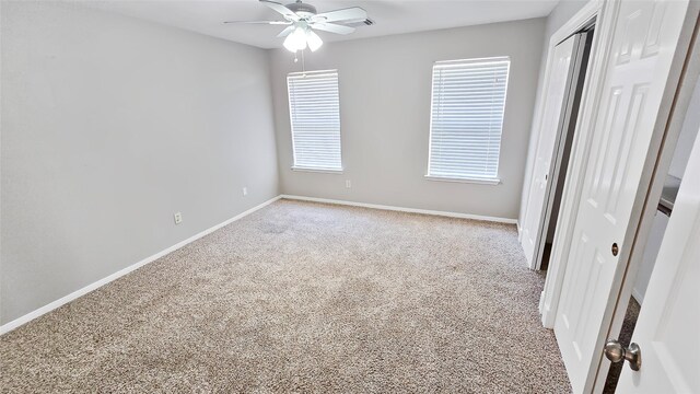 unfurnished bedroom featuring ceiling fan and light colored carpet