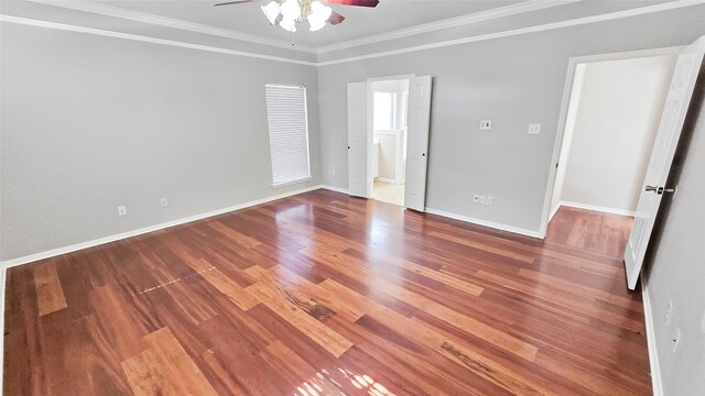 unfurnished room featuring hardwood / wood-style floors, ceiling fan, and crown molding