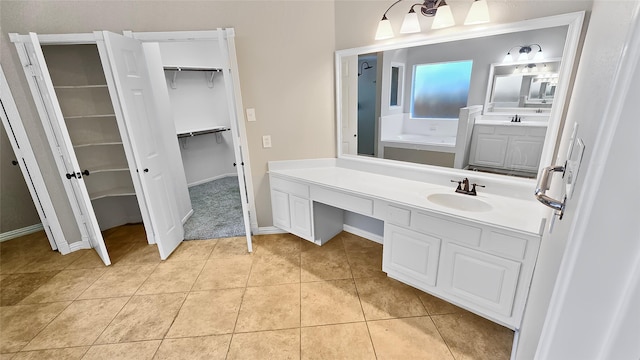 bathroom with a bathtub, tile patterned flooring, and vanity