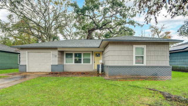 single story home with a garage and a front yard