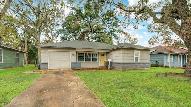 single story home featuring a garage and a front yard