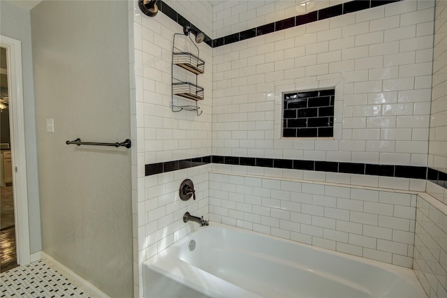 bathroom featuring tile patterned floors and tiled shower / bath