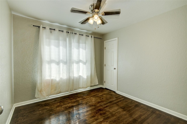 unfurnished room featuring ceiling fan and dark hardwood / wood-style flooring