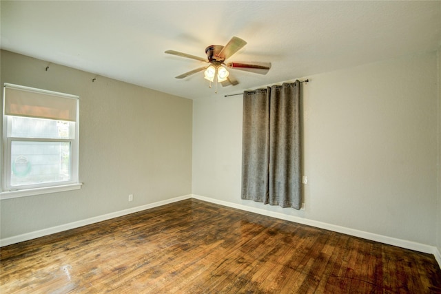 unfurnished room with ceiling fan and dark hardwood / wood-style flooring