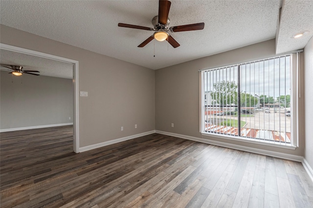 spare room featuring a textured ceiling, dark hardwood / wood-style floors, and ceiling fan