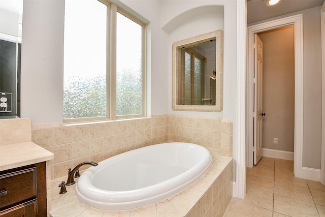 bathroom with tile patterned flooring, vanity, and plus walk in shower