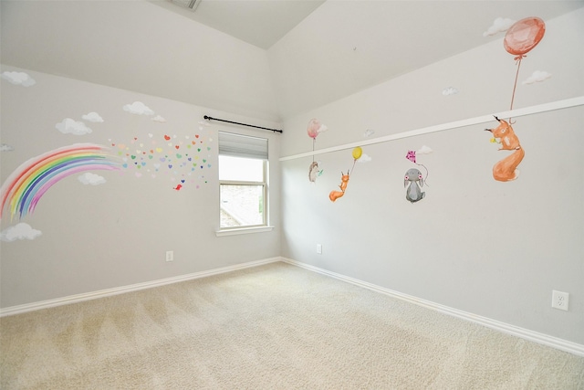 unfurnished room featuring carpet floors and vaulted ceiling