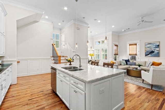 kitchen with pendant lighting, sink, an island with sink, and a healthy amount of sunlight