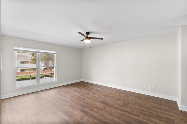 spare room with dark hardwood / wood-style floors and ceiling fan