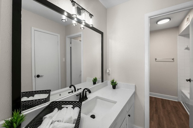 bathroom with hardwood / wood-style floors, vanity, and shower / tub combination