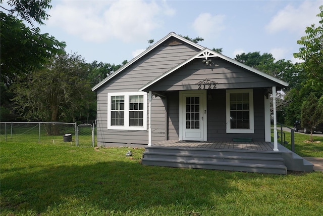 exterior space featuring covered porch and a front yard