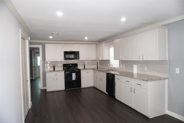 kitchen featuring black appliances, sink, light stone countertops, dark hardwood / wood-style flooring, and white cabinetry