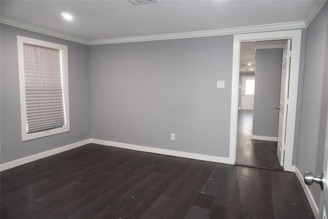 empty room with dark hardwood / wood-style flooring and ornamental molding