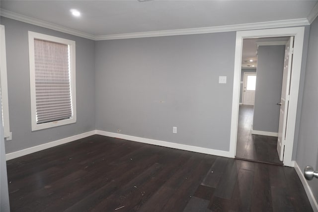 empty room with crown molding and dark hardwood / wood-style floors