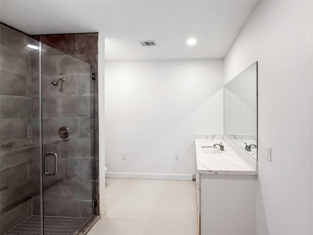 bathroom featuring tile patterned flooring, vanity, toilet, and walk in shower