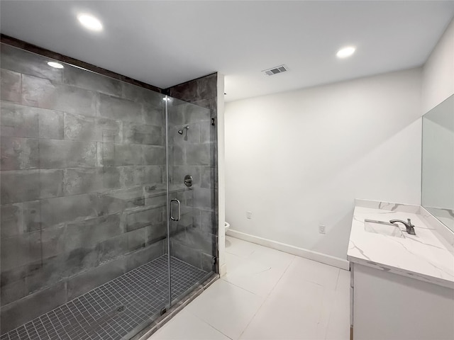 bathroom featuring vanity, toilet, and a shower with shower door