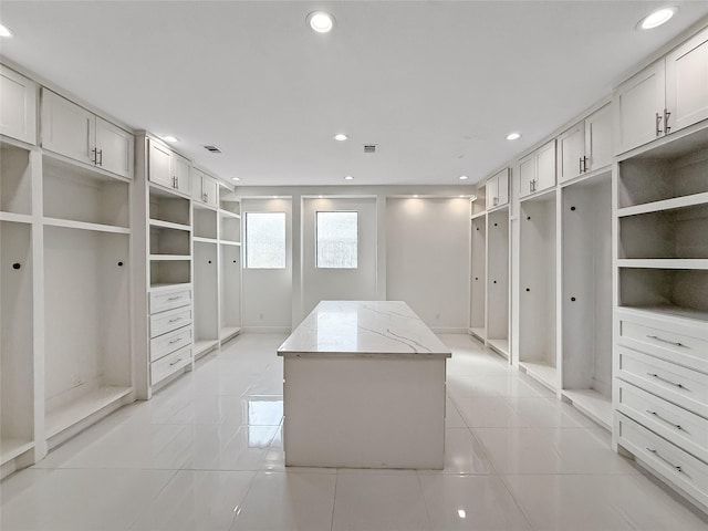 spacious closet with light tile patterned floors