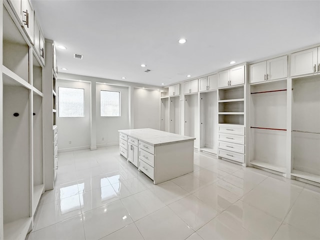 spacious closet with light tile patterned floors