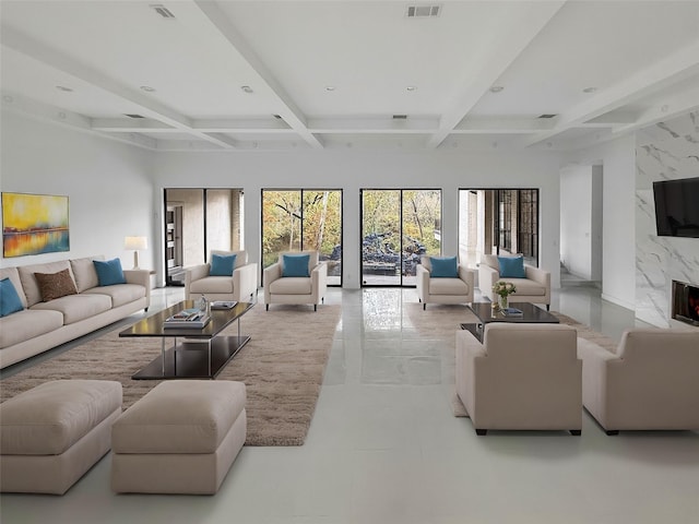 living room with beamed ceiling, a premium fireplace, and coffered ceiling