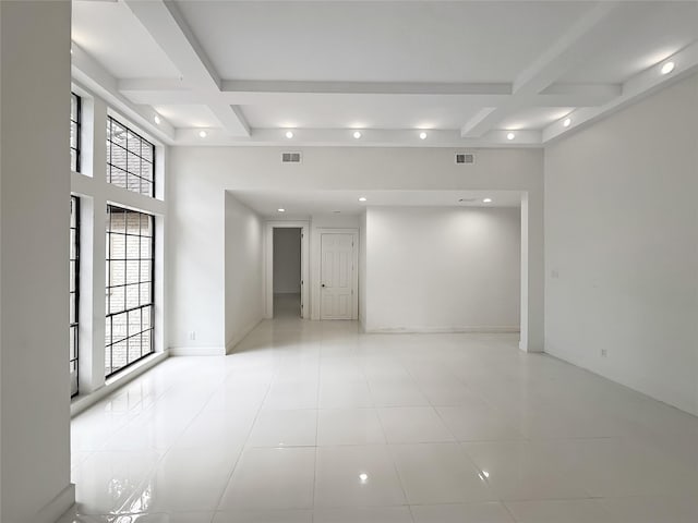 tiled empty room with beam ceiling and coffered ceiling