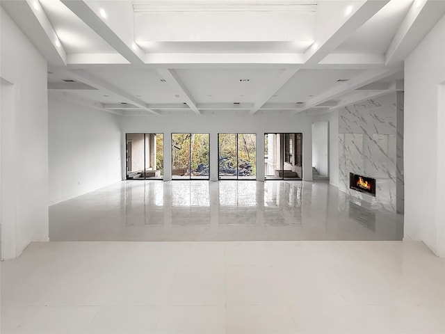 unfurnished living room featuring beam ceiling, a high end fireplace, and coffered ceiling